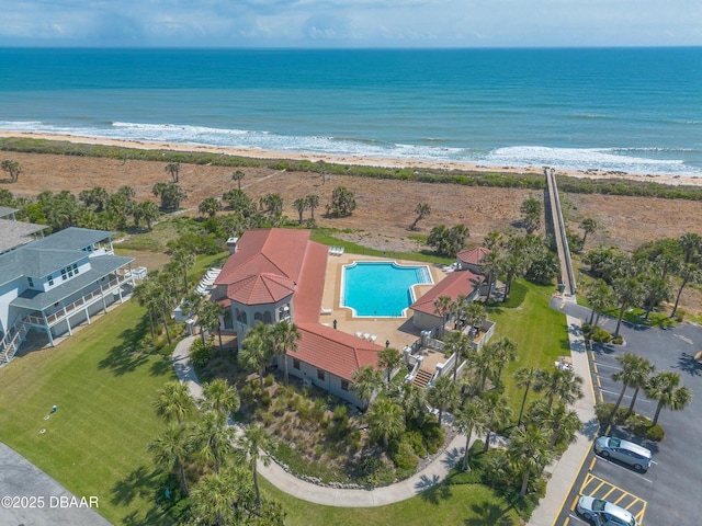 drone / aerial view with a beach view and a water view