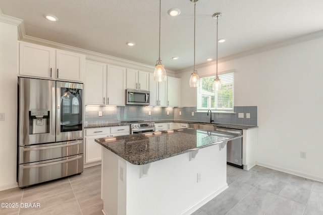 kitchen with a center island, dark stone counters, appliances with stainless steel finishes, and backsplash