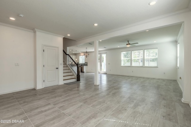 unfurnished living room with crown molding, stairs, baseboards, recessed lighting, and ceiling fan with notable chandelier