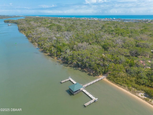 aerial view with a water view and a forest view