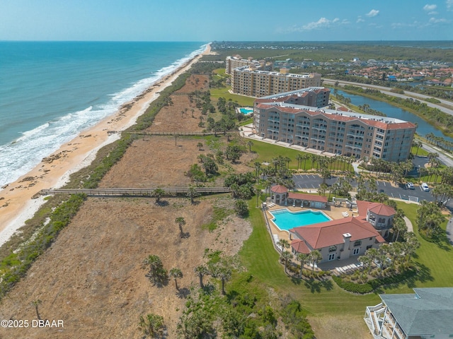 drone / aerial view featuring a water view and a beach view