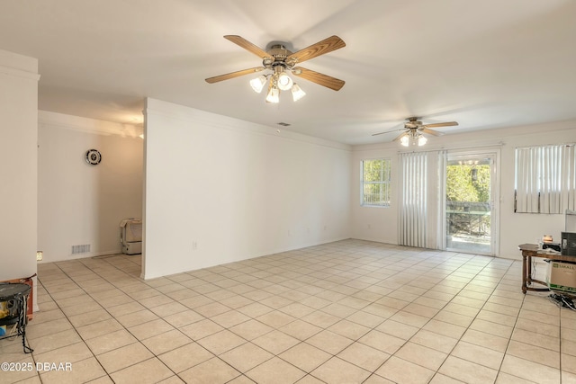 tiled empty room with ceiling fan and crown molding