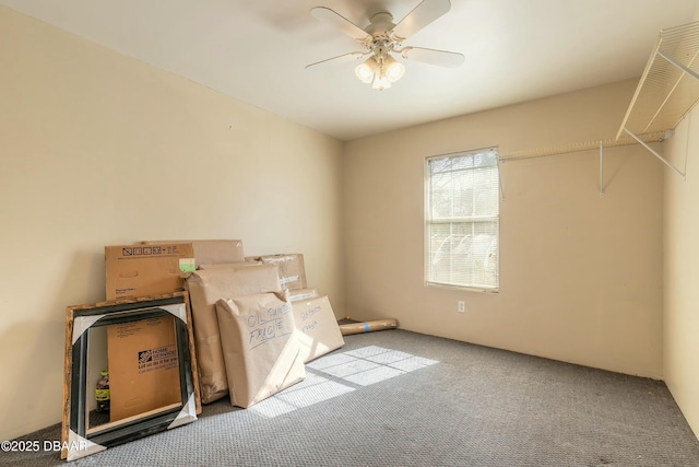 interior space with ceiling fan and light colored carpet