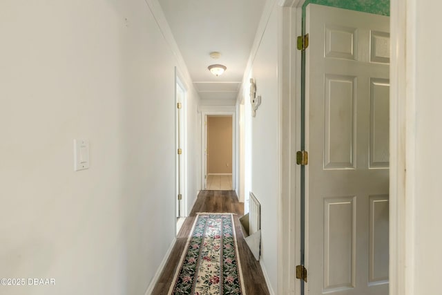 hall with dark hardwood / wood-style flooring and ornamental molding