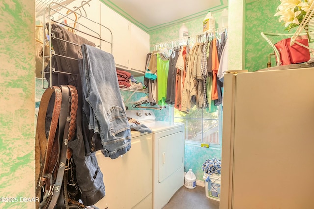 washroom with cabinets and washing machine and clothes dryer