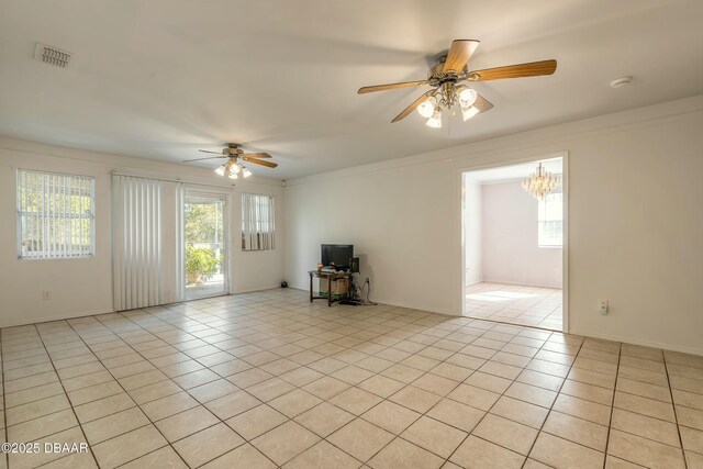 unfurnished living room featuring ceiling fan, crown molding, and light tile patterned floors