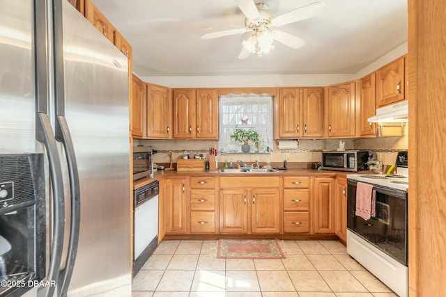 kitchen featuring appliances with stainless steel finishes, ceiling fan, sink, light tile patterned floors, and range hood