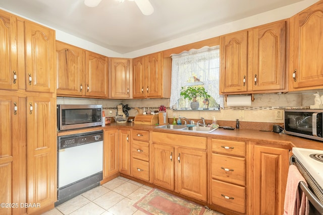 kitchen with dishwasher, sink, backsplash, stove, and light tile patterned floors