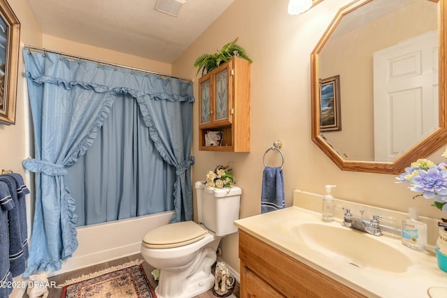 full bathroom with a textured ceiling, vanity, toilet, and shower / bath combo with shower curtain