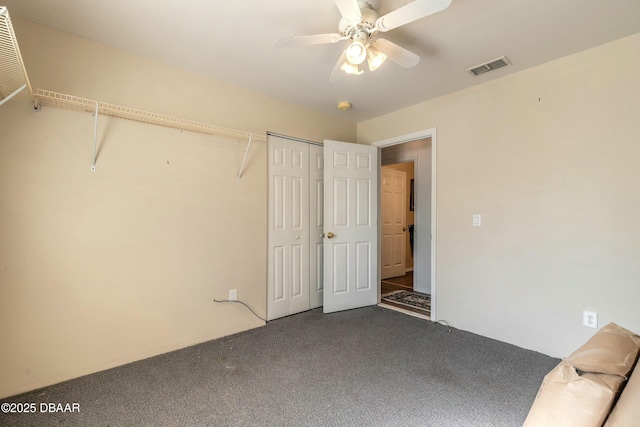 unfurnished bedroom featuring ceiling fan, a closet, and carpet floors