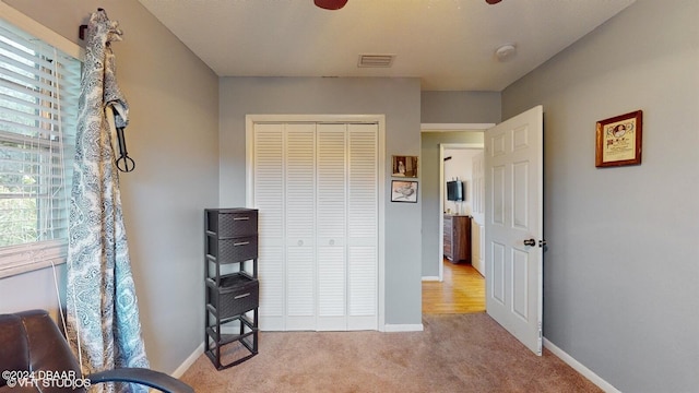 sitting room featuring plenty of natural light and light colored carpet