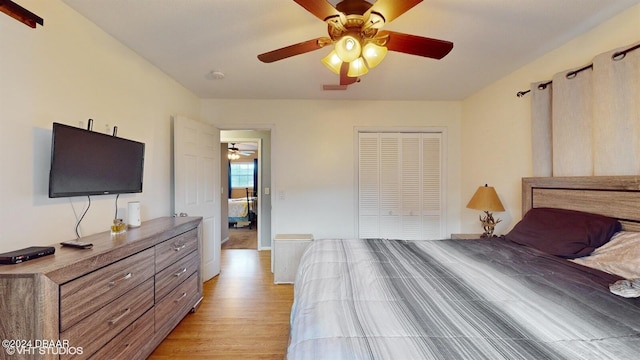 bedroom with ceiling fan, a closet, and light hardwood / wood-style flooring