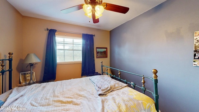 bedroom featuring ceiling fan and lofted ceiling