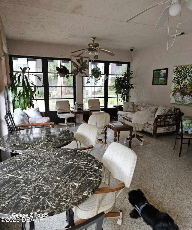 living room with ceiling fan and carpet