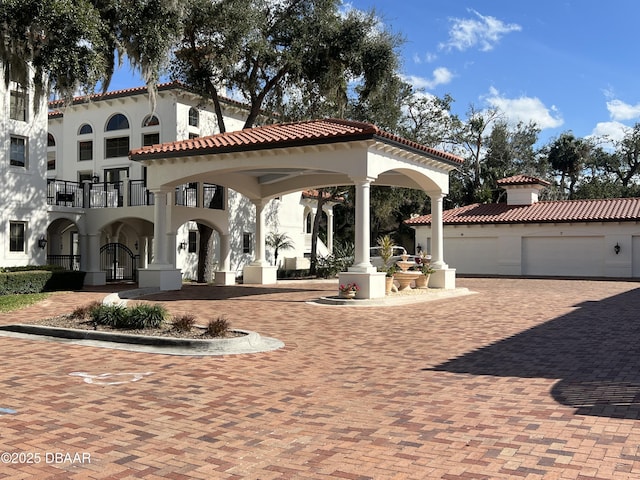 exterior space featuring a tile roof and stucco siding