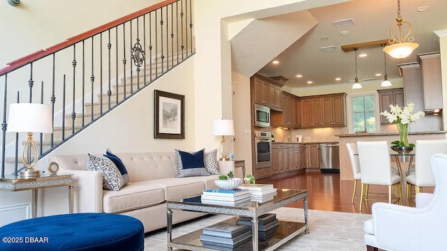 living room with light wood-style flooring, stairway, and recessed lighting