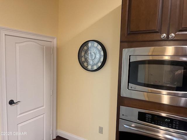 interior space featuring stainless steel appliances and dark brown cabinets