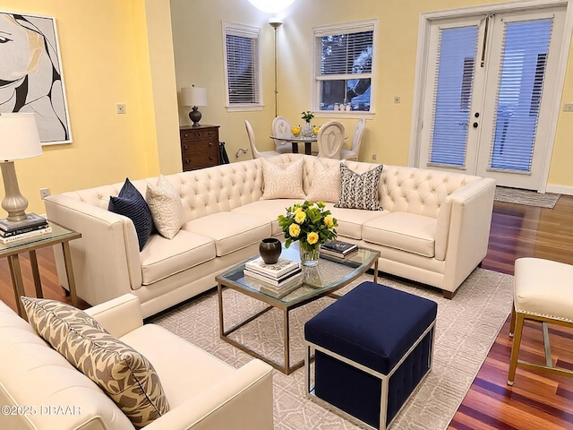 living area featuring wood finished floors and french doors