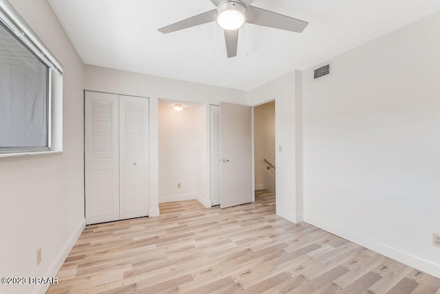 unfurnished bedroom with light wood-type flooring and ceiling fan