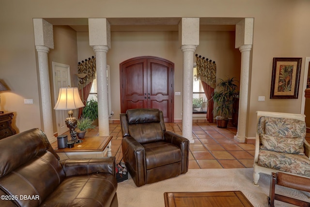 6 Rosalyn Lndg, Daytona Beach, FL 32118 - living room featuring ornate columns, light tile patterned flooring, and arched walkways