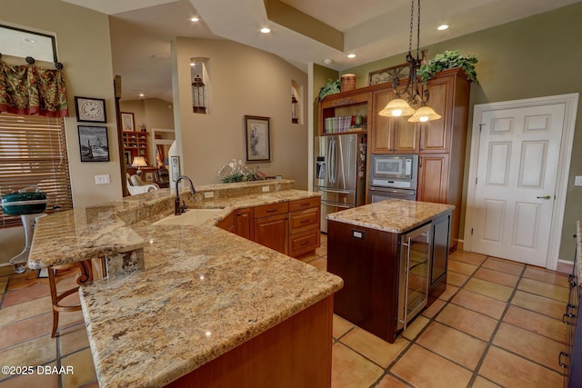 6 Rosalyn Lndg, Daytona Beach, FL 32118 - kitchen with a large island, appliances with stainless steel finishes, beverage cooler, recessed lighting, and brown cabinetry