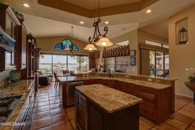6 Rosalyn Lndg, Daytona Beach, FL 32118 - kitchen featuring stainless steel appliances, a kitchen island, recessed lighting, vaulted ceiling, and glass insert cabinets