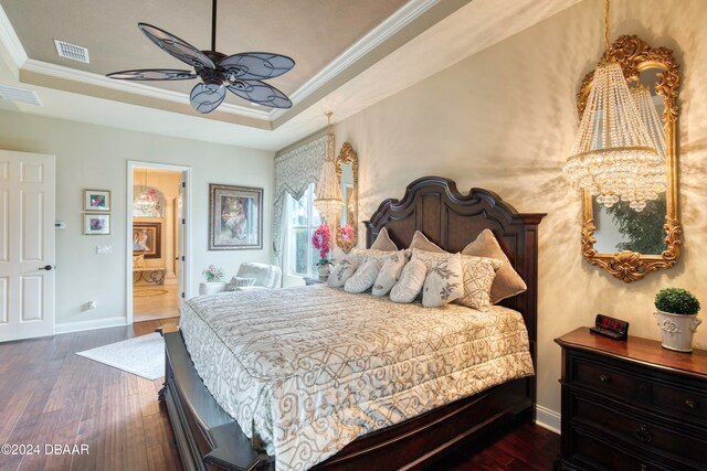 bedroom featuring dark wood-type flooring, ceiling fan, connected bathroom, and ornamental molding