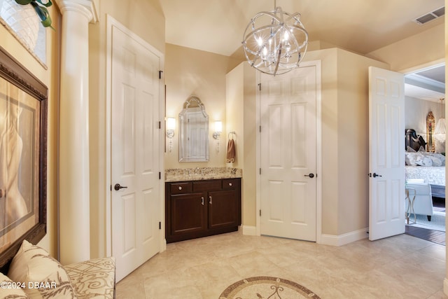 bathroom featuring vanity, tile patterned floors, and a notable chandelier