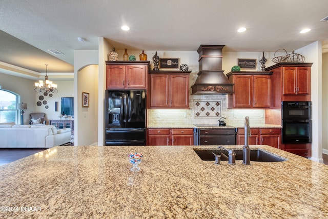 kitchen with black appliances, backsplash, custom range hood, a notable chandelier, and sink