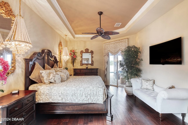 bedroom with dark hardwood / wood-style floors, crown molding, a raised ceiling, and ceiling fan with notable chandelier