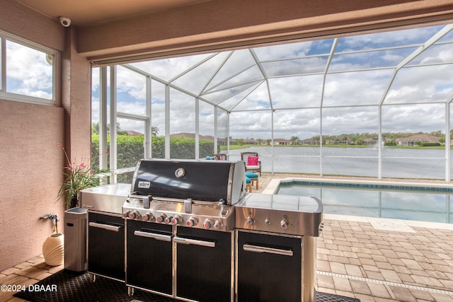 view of patio / terrace with a lanai and exterior kitchen