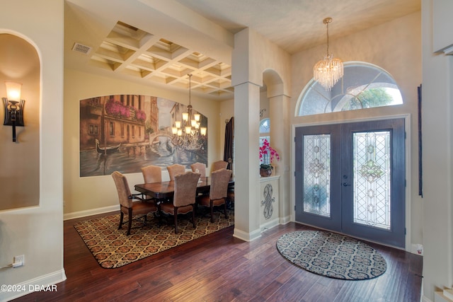 entrance foyer featuring french doors, an inviting chandelier, coffered ceiling, beamed ceiling, and dark hardwood / wood-style floors