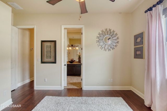 unfurnished room with ceiling fan and dark hardwood / wood-style floors