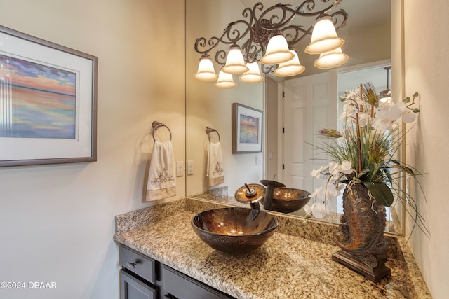 bathroom featuring vanity and a notable chandelier