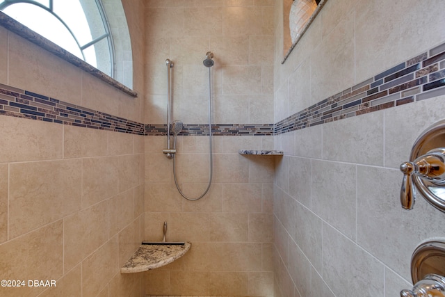 bathroom with tiled shower