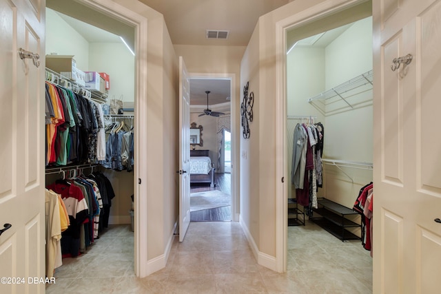 spacious closet featuring light tile patterned floors and ceiling fan