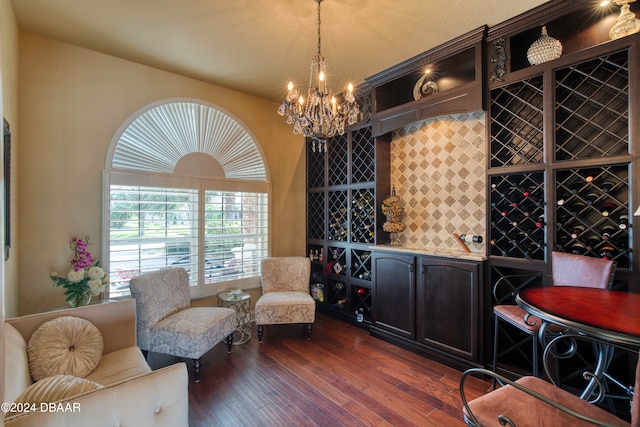 wine area featuring a notable chandelier and dark hardwood / wood-style floors