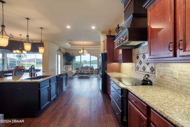 kitchen featuring sink, black appliances, tasteful backsplash, decorative light fixtures, and dark wood-type flooring