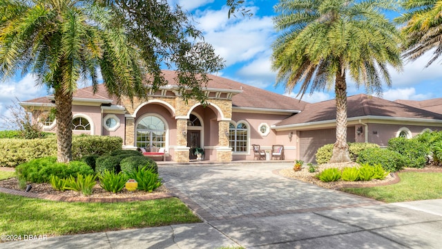 mediterranean / spanish-style house featuring a garage