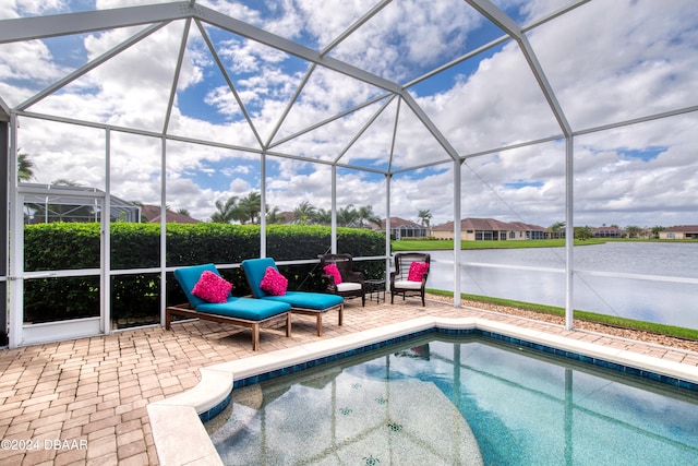 view of swimming pool with a lanai, a water view, and a patio area