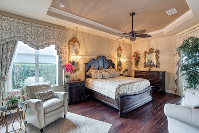 bedroom with ceiling fan, dark hardwood / wood-style floors, a raised ceiling, and crown molding