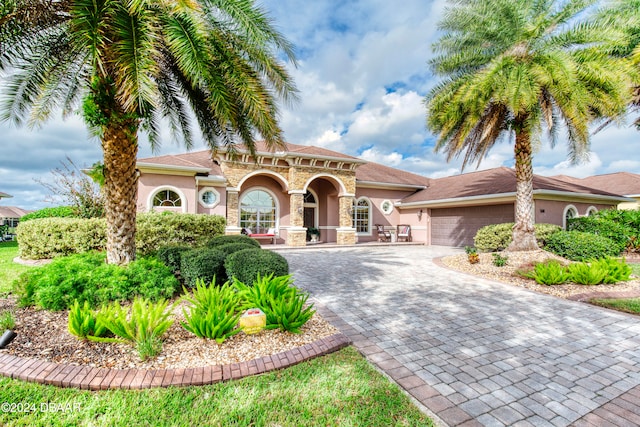 mediterranean / spanish home featuring a garage