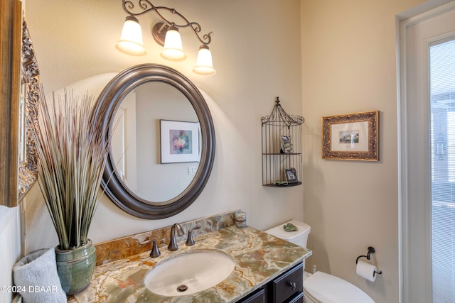 bathroom with toilet and vanity