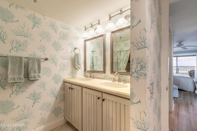 bathroom with hardwood / wood-style flooring, vanity, and ceiling fan