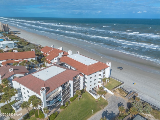 bird's eye view with a water view and a beach view