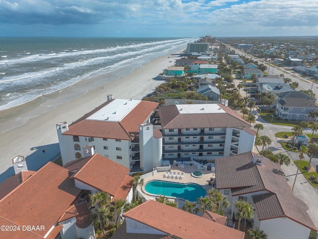 aerial view with a water view and a beach view