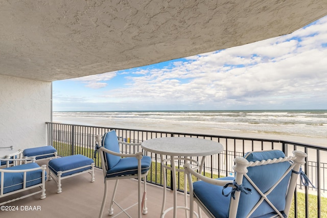 balcony with a view of the beach and a water view