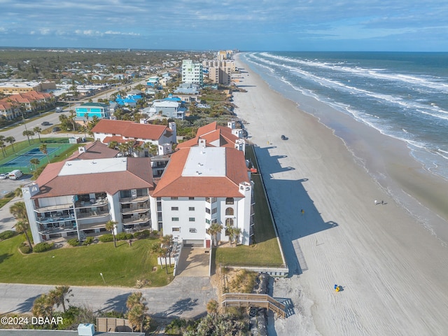 drone / aerial view with a water view and a view of the beach