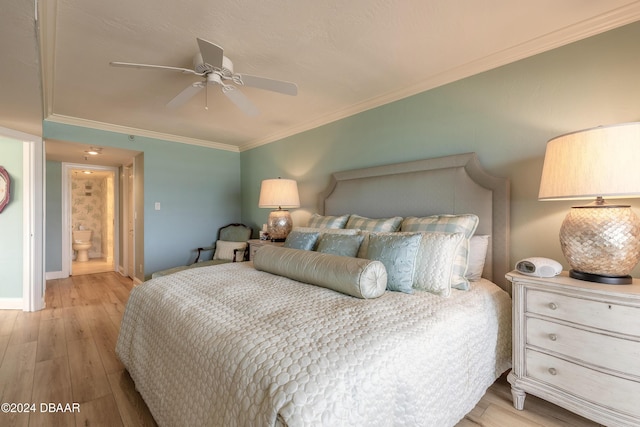 bedroom featuring light wood-type flooring, ceiling fan, crown molding, and connected bathroom