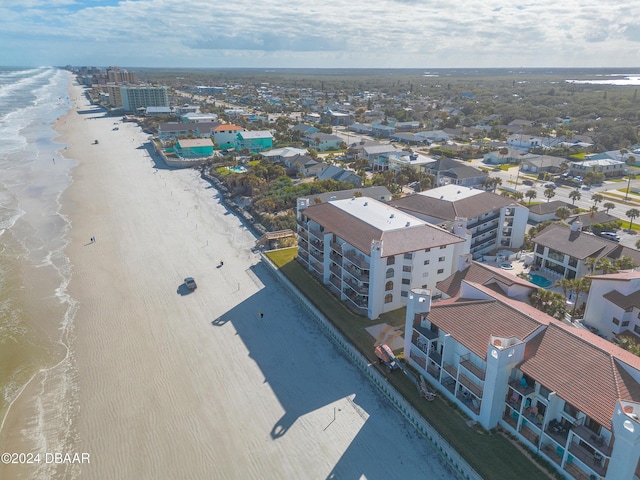 birds eye view of property featuring a water view and a beach view